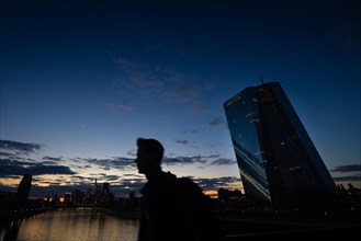 The remaining light of day is reflected in the glass facade of the European Central Bank (ECB) in