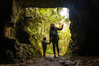 A child and his mother in a cave in the Laurisilva forest of Los tilos de Moya, Gran Canaria