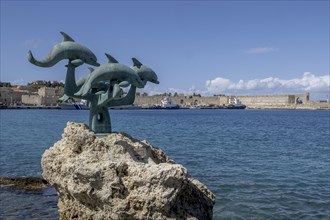 Dolphin statue in Kolona harbour, Rhodes, Dodecanese archipelago, Greek islands, Greece, Europe