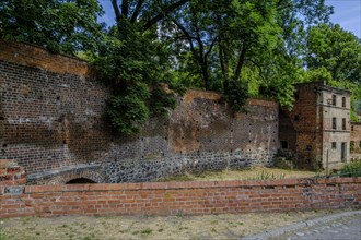 Abandoned, dilapidated building, integrated into the old historic town wall of Namyslow (Namslau),