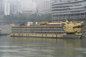 Yichang, Hubei Province, China, Asia, A large ship with a dragon design on an urban riverbank in