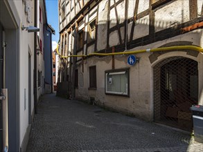 View through the Trinklaube, a winding narrow alley in the old town of Wangen im Allgaeu, Upper