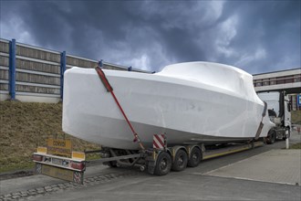 Heavy goods vehicle loaded with a motor yacht in a car park, Mecklenburg-Vorpommern, Germany,