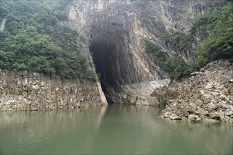 Cruise ship on the Yangtze River, Hubei Province, China, Asia, A cave opens into a rock next to a