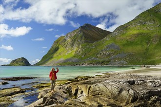 Landscape with sea at the sandy beach of Haukland (Hauklandstranda) with the mountain Veggen. A