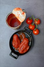 Whole tinned tomatoes in a pot, tomatoes and tins