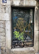 Graffiti-covered door in a stone building, Split, Dalmatia, Croatia, Europe