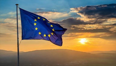 The flag of the EU flutters in the wind, isolated, towards sunset