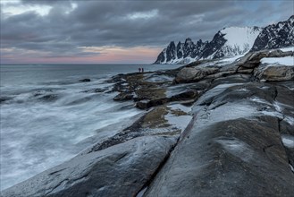Rocky coast with sea spray, mountains, winter, cloudy, Tungeneset, Senja, Troms, Norway, Europe