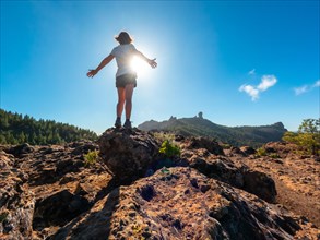 A woman hiker at a viewpoint of Roque Nublo in Gran Canaria, Canary Islands