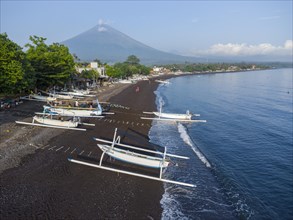 Fishermen coming back from fishing in the morning, in the background Mount Agung, Amed, Karangasem,