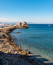 Mandraki port and bay in Rhodes. Historic windmills in the background