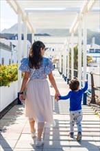 A mother with her son on vacation at Puerto de Las Nieves in Agaete on Gran Canaria, Spain, Europe