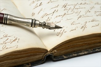 Pen on diary with old writing