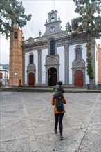 A mother with her son visiting the Basilica of Nuestra Senora del Pino in the municipality of Teror