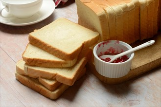 Toast, slices of toast and bowls of jam