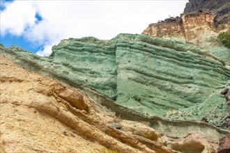 Detail of the colors in the Natural Monument Azulejos de Veneguera or Rainbow Rocks in Mogan, Gran