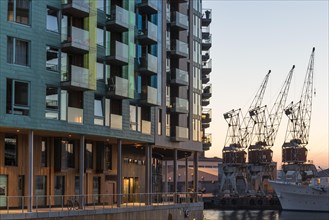 Modern residential buildings by the marina, cranes, Tjuvholmen, Aker Brygge, Oslo, Norway, Europe