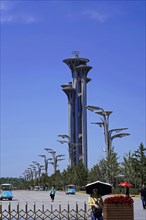 Beijing, China, Asia, View of a prominent Olympic tower on a sunny day with some passers-by, Asia