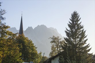 Old parish church of St Martin in the evening light, Wetterstein mountains with Zugspitze massif,