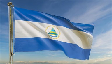 The flag of Nicaragua flutters in the wind, isolated against a blue sky