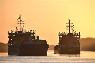 Shipping traffic, cargo ship at sunrise in the Kiel Canal, Kiel Canal, Schleswig-Holstein, Germany,
