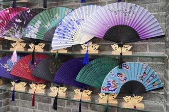 Stroll through the restored Tianzifang district, A selection of colourful, decorative fans