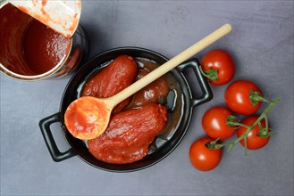 Whole tinned tomatoes in a pot, tomatoes and tins