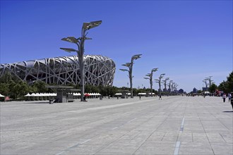 Beijing, China, Asia, Wide perspective of an empty square with a stadium in the background under a