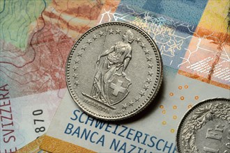 Swiss coin on banknotes, Swiss franc, Switzerland, Europe