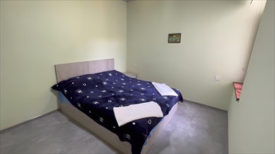 Interior of a bedroom in a new house with a double bed