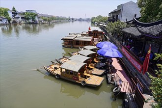 Excursion to Zhujiajiao water village, Shanghai, China, Asia, Wooden boat on canal with view of