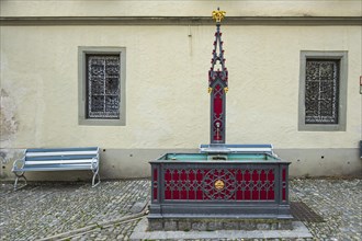 Historic fountain in neo-Gothic style on Postplatz in the old town centre of Wangen im Allgaeu,