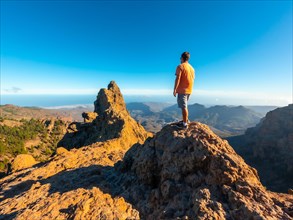 A man looking at the top of Pico de las Nieves in Gran Canaria, Canary Islands
