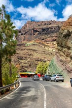 Beautiful road under the natural monument at the Azulejos de Veneguera or Rainbow Rocks in Mogan,