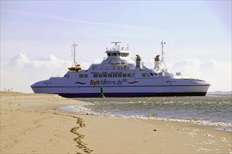 Sylt, Schleswig-Holstein, The Sylt ferry in the sea near a beach under a blue sky, Sylt, North
