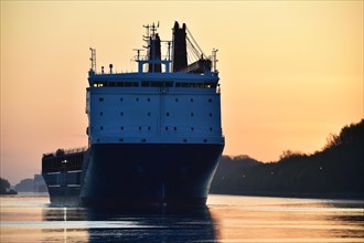 Shipping traffic, cargo ship at sunrise in the Kiel Canal, Kiel Canal, Schleswig-Holstein, Germany,