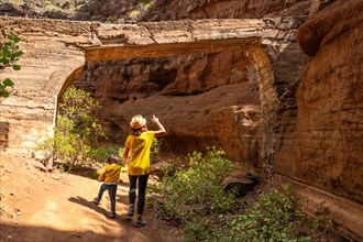 A woman with her child in the limestone canyon Barranco de las Vacas on Gran Canaria, Canary
