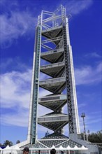 Beijing, China, Asia, Modern tower with metallic scaffolding structure in front of a deep blue sky,
