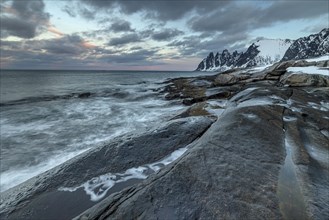 Rocky coast off Bergen, sea, spray, waves, morning mood with clouds, winter, Tungeneset, Senja,