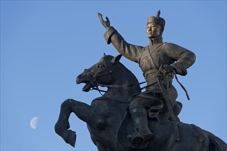 Crescent moon behind statue of Damdin Suekhbaatar on Genghis Khan Square or Suekhbaatar Square in