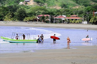 San Juan del Sur, Nicaragua, People with surfboards prepare for surfing on the beach, Central