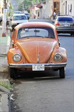 Leon, Nicaragua, Rusty orange VW Beetle parked by the road, Central America, Central America