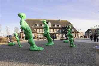 Westerland, Sylt, Schleswig-Holstein, Green sculptures of figures on a public square in the town,