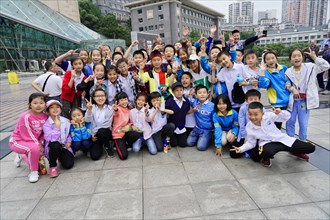 Chongqing, Chongqing Province, China, Asia, A group of smiling children showing Victory signs,