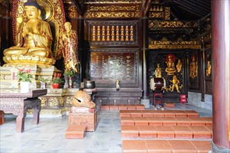 Chongqing, Chongqing Province, China, Asia, Golden Buddha statue in a Chinese temple with altar and