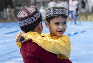 GUWAHATI, INDIA, APRIL 11: Muslim children greets each other after perform Eid al-Fitr prayer at