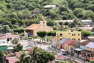 San Juan del Sur, Nicaragua, Detailed view of a lively place with a church, people and city life,