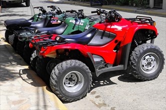 San Juan del Sur, Nicaragua, Several all-terrain vehicles parked in a row on the side of a road,