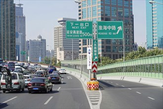 Traffic in Shanghai, Shanghai Shi, People's Republic of China, city motorway with direction signs,